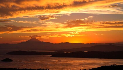 Golden sunset over mountains and water