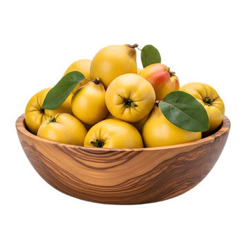 Close-up shot of a wooden bowl filled with ripe, yellow quinces and green leaves.