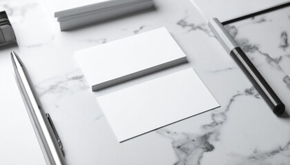 Naklejka premium Elegant White Business Cards on Marble Table with Pens Stationery