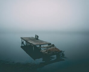 Misty lake, dilapidated dock
