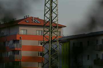This image captures a contemporary urban landscape featuring residential buildings and a tower, highlighting modern architecture and city life.