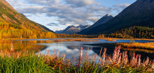 Beautiful panoramic landscape of Tern lake with mountain reflections in autumn time in Alaska.