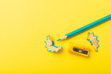 Pencil sharpener on bright colored background. Pencil and pencil shavings. Stationery. School...