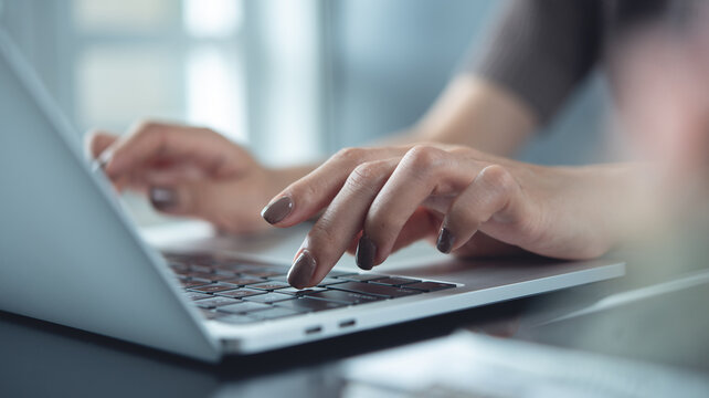 Close up of business woman hands working, typing on laptop computer keyboard, surfing the internet on office desk, online working, telecommuting, freelancer at work concept - Powered by Adobe