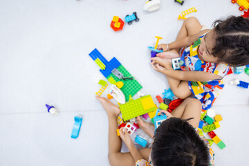 Kindergarten kids little boy and girl enjoy play toy block building