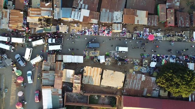 Aerial view of a bustling market street in an african city, showcasing the vibrant life and commerce