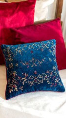 Deep blue velvet throw pillow with embroidered floral pattern