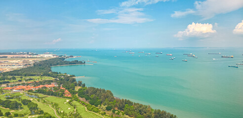 Aerial view of the Singapore Strait, Ocean liner, tanker and Cargo Ship from airplane windows during flight landing to Changi International Airport, Singapore.