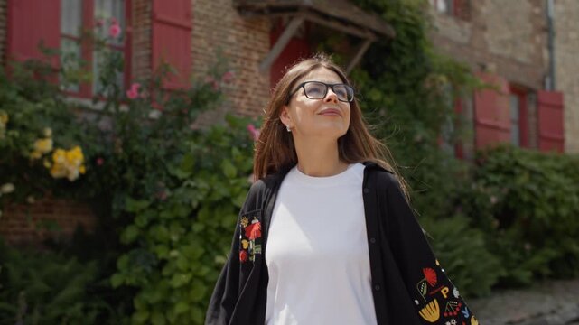 Tourist walking through the picturesque village of Gerberoy in France. Travel and tourism of a girl in Europe.