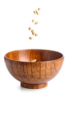Wooden bowl with seeds falling