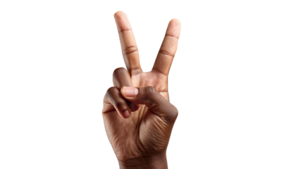 A human hand with two fingers up forms a victory sign, a gesture of peace and success.