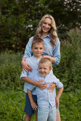 Fototapeta premium Mom spends time outdoors with her sons.