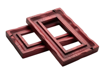 Two distinct hand-carved wooden frames, deep crimson, natural grain, beveled edge, casually overlapped on white background with soft studio light, raw creativity and authentic artisanal craftsmanship