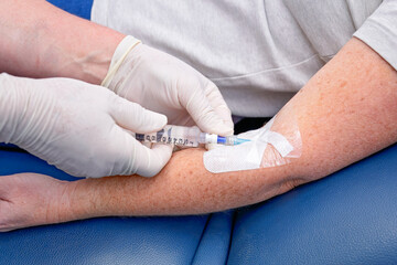 Nurse or doctor inserting IVC cannula into vein of patient, for IV fluids and medication, gp general practice australia, medical healthcare clinic