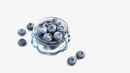 blueberries in a bowl. The concept of proper nutrition and diet in the summer, a glass small blue...