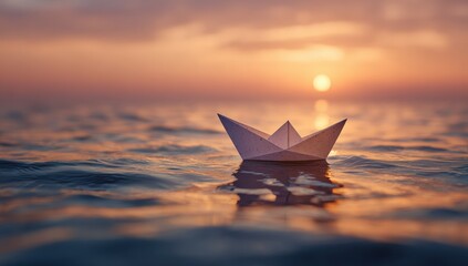 Paper boat on sunset sea