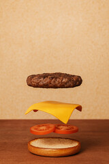 Flying hamburger on a wooden background