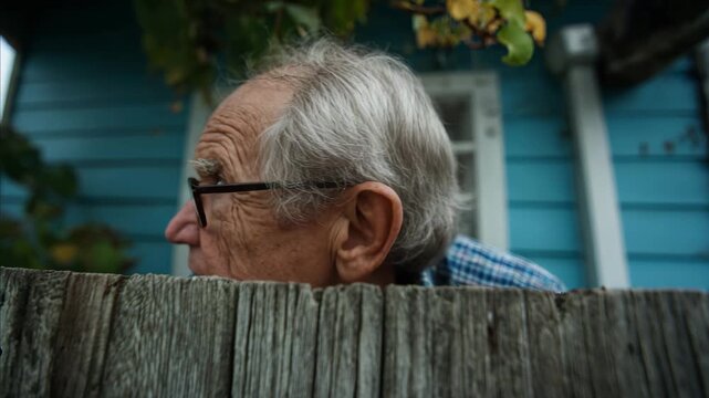 Nosy Old Man Peeking Over Fence Curious Neighbor Concept Funny Elderly Man with Glasses Looking Suspicious Suburban Humor Stock Video