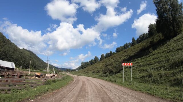 Video of driving in a car along country muddy road over village Nizhny Komar. in Altai Krai.