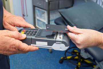 Patient paying for medical healthcare clinic doctor appointment in australia, medicare insurance