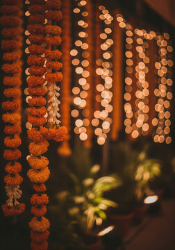Diwali decoration traditional Indian decoration of hanging marigold flower garlands for a Diwali or wedding celebration, with a warm golden bokeh background.