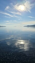 Bright view of Lago Ranco on a sunny day with blue skies, sparkling waters, and surrounding mountains, showcasing the natural beauty of southern Chile.