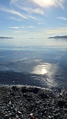 Bright view of Lago Ranco on a sunny day with blue skies, sparkling waters, and surrounding mountains, showcasing the natural beauty of southern Chile.