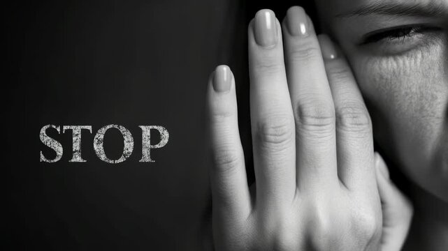 A close-up shows a stressed woman's face as she covers her face to stop further assault and violence. Help prevent domestic outrage by addressing women's vulnerability