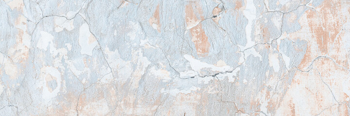 Vintage wall texture. Rough surface of the plastered concrete wall of the building. A pattern with many cracks and old faded peeling paint. Perfect for background and design. Closeup.