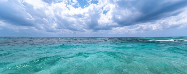 Turquoise ocean under a cloudy sky