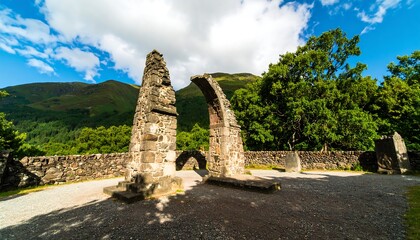 Ruined archway, stone pillars, sunny landscape
