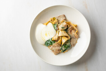 Creamy truffle-laden pappardelle nestles mysteriously with earthy mushrooms, perfect for White Truffle Day and gourmet indulgence