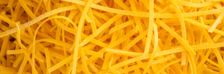 Golden strands of shredded cheese, culinary labyrinthine delight, cheesy comfort celebrating National Cheese Day, vibrant dairy indulgence