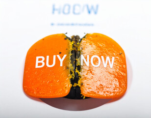 Orange buy now button cracked open revealing dark interior broken