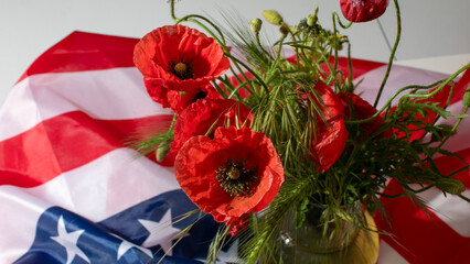Vibrant crimson poppies contrast sharply against the patriotic Stars and Stripes, evoking Memorial...