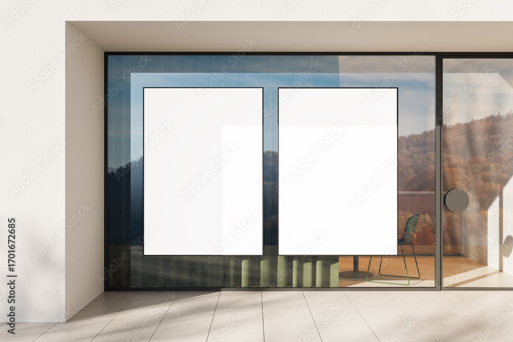 Poster modern glass storefront with two blank vertical poster mockups in black frames reflecting natural la