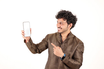 Fototapeta premium Smiling Indian man in traditional kurta showing smartphone with blank screen isolated on white background