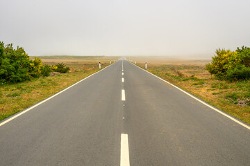 A road leads straight ahead into the next village on the island of Madeira