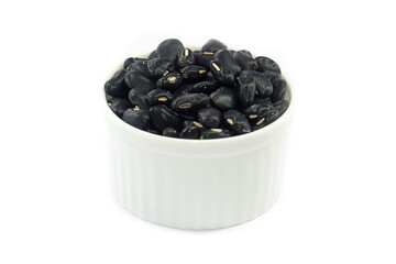 Black beans in a bowl on a white background.