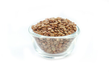 Vicia lens or Lens culinaris (Lens culinaris). Lentils brown, contains protein and soluble fiber, is a source of vitamin B.in a bowl on a white background.