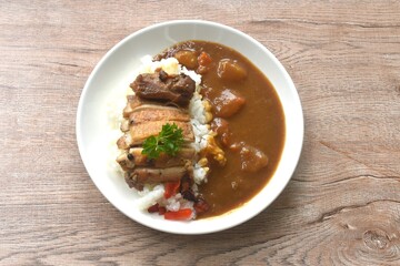 grilled slice chicken topping plain rice dressing potato and carrot in Japanese curry on plate 