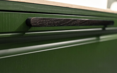 Green vanity closeup. Wooden handle. Premium minimalism