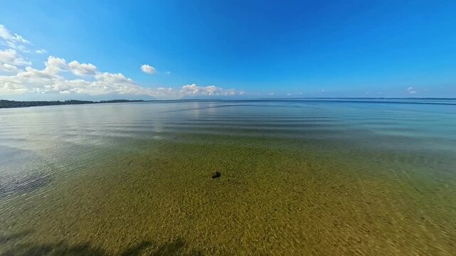 4K Timelapse video with moving clouds and waves at Lake Chiemsee, Chieming, Traunstein, Chiemgau, Bavaria, Germany