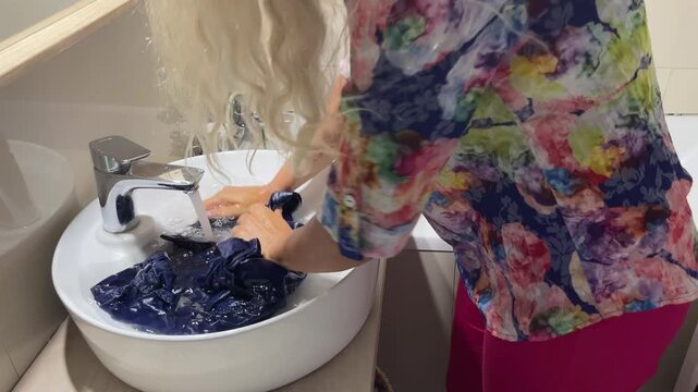 Washing clothes in the bathroom sink,