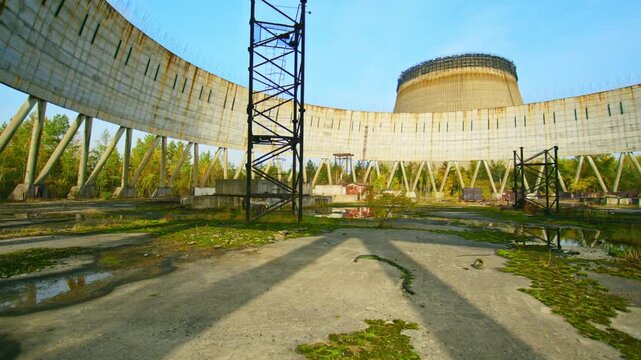 Footage capturing the eerie and desolate scene of the unfinished cooling tower for the 5th power unit of the Chernobyl Nuclear Power Plant, a stark reminder of the 1986 disaster and the halted constru
