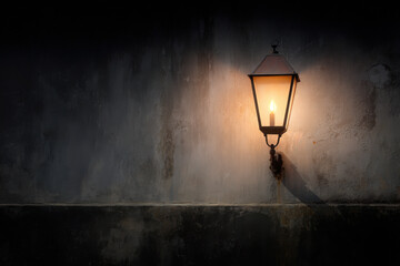 warm glow of flickering candle illuminates antique lantern casting enchanting shadows on weathered wall