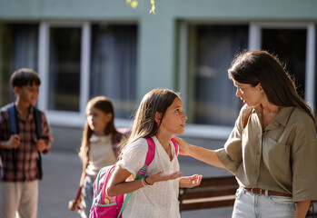 Child interacting with mother outside school