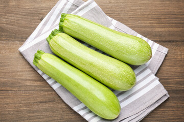 Fresh ripe zucchinis on wooden table, top view