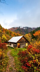 Rustic cabin nestled in autumnal mountain valley