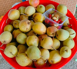Abundant fresh pears and strawberries in a rustic style in vibrant colors representing healthy eating and summer harvest